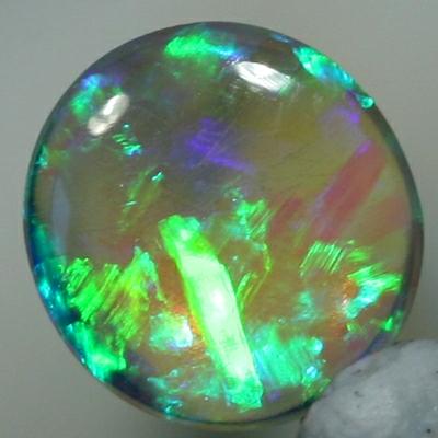 SOLID CRYSTAL OPAL Sparkles of green show in a Chaff pattern, totally clean body.